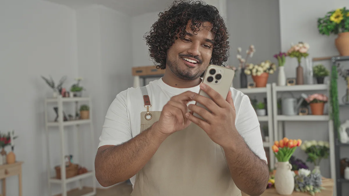 Local small business owner using social media on phone.