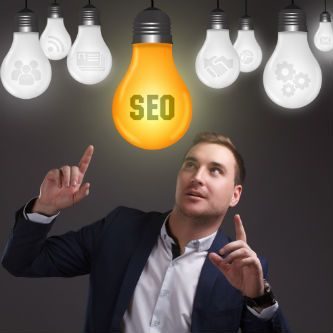 Man checking SEO services light bulb to see if it is on