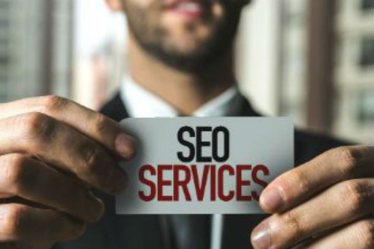 Man holding SEO services sign