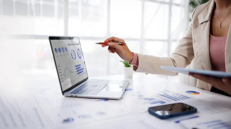 Woman choosing the right service on her laptop at a table work station location.