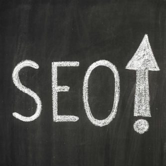 Top SEO Companies SEO on chalk board with up arrow exclamation up arrow
