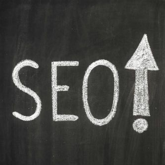 Top SEO Companies SEO on chalk board with up arrow exclamation up arrow