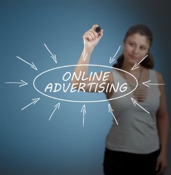 Woman with marker writing online marketing on a board
