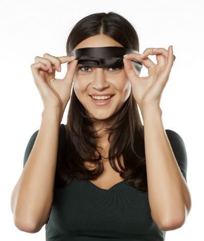 Woman taking off her blindfold and smiling